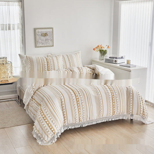 Neatly made bed with patterned comforter in a bright bedroom